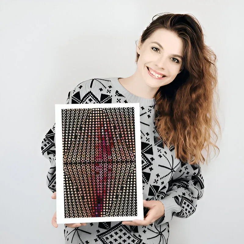 Woman holding a framed artwork with geometric patterns on a plain background