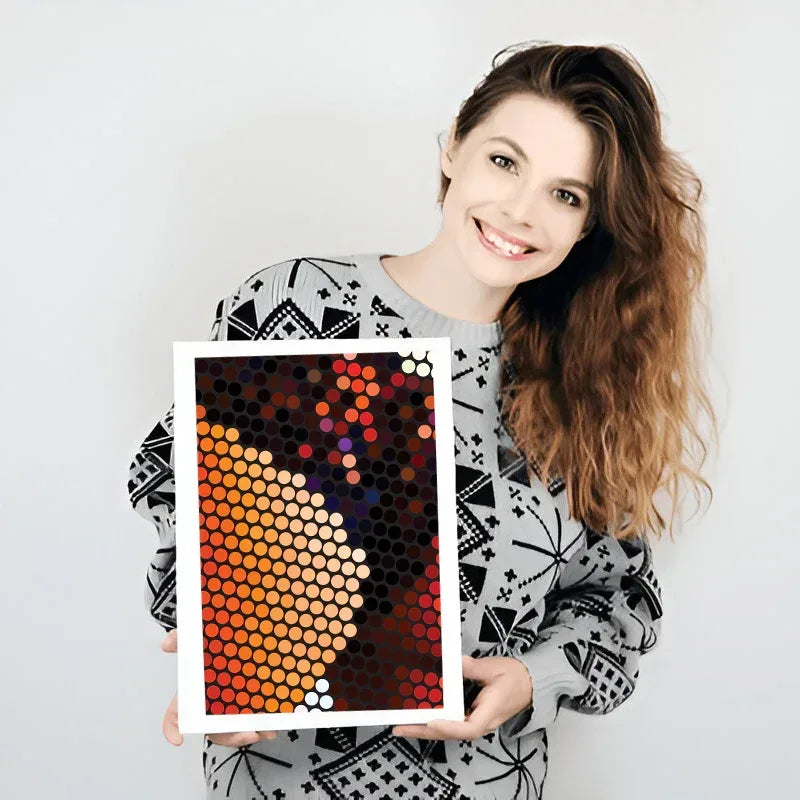 Woman holding a colorful abstract art print against a plain background