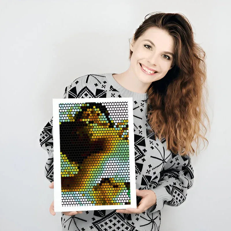 Woman holding a colorful mosaic art piece against a white background