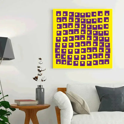 Abstract art piece with purple and yellow squares on a white wall above a sofa.