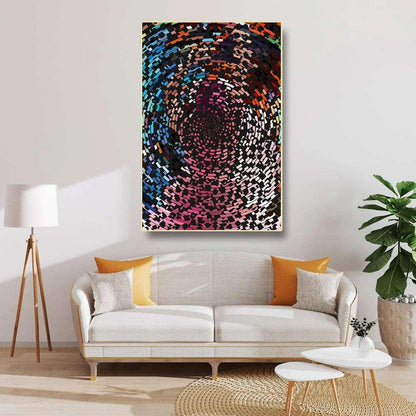 Living room with a colorful abstract painting on the wall, a white sofa with orange and yellow cushions, and a plant.