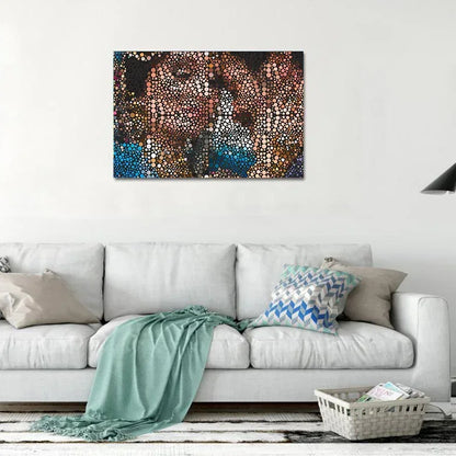 Abstract painting on a wall above a white sofa with decorative pillows and a blanket.
