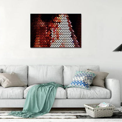 Geometric triangle pattern wall art above a white sofa in a living room.
