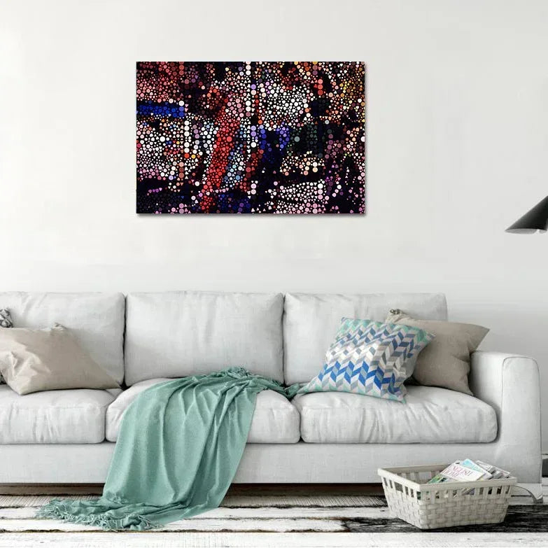Colorful abstract painting on a white wall above a white sofa with decorative pillows.