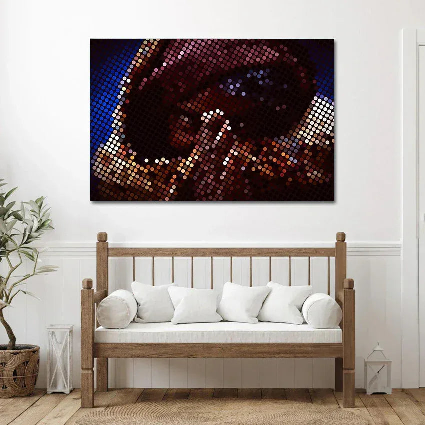 Abstract art piece on a wall above a wooden bench with white cushions.