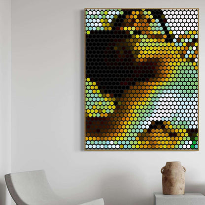 Colorful abstract art piece on a white wall with a chair and vase in the foreground.