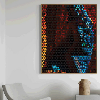 Colorful abstract art piece on a white wall with a chair and vase in the foreground.