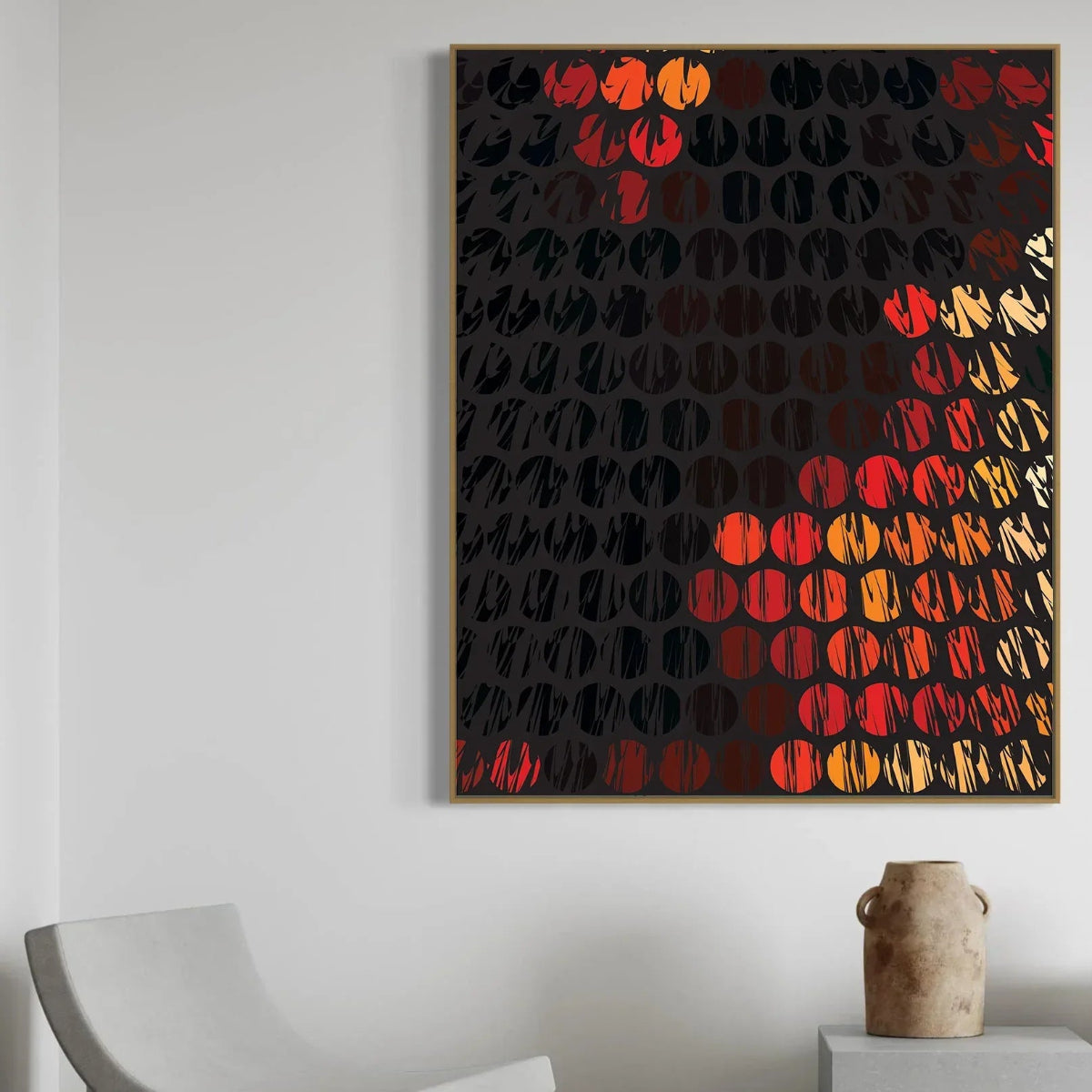 Abstract art piece with circular patterns in red, orange, and black on a dark background, framed and hanging on a wall.
