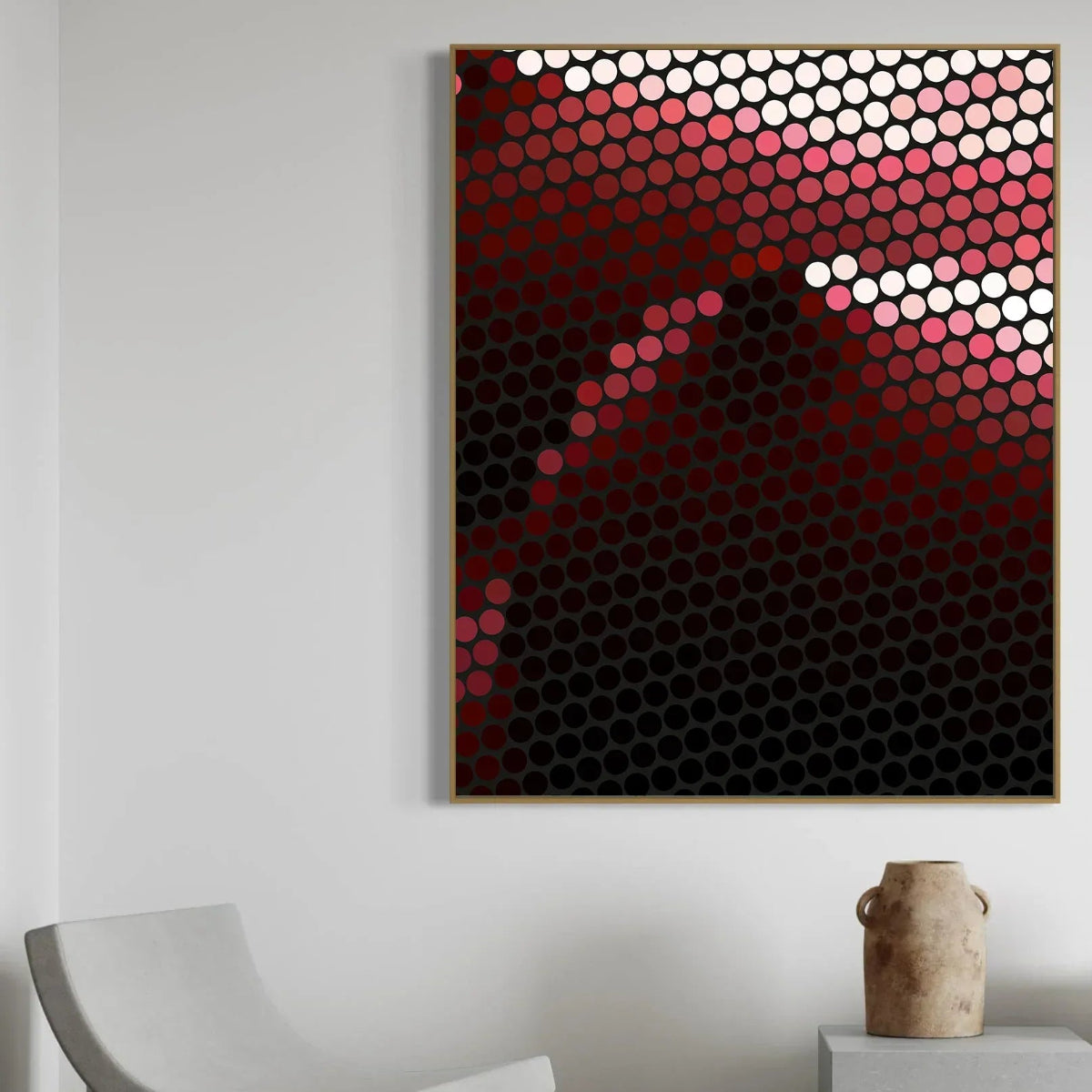 Abstract art piece with circular patterns in red, white, and black on a white wall.