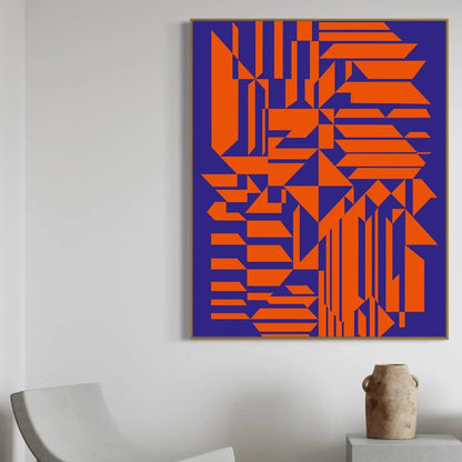 Geometric abstract art with orange shapes on a blue background, framed and hanging on a wall.