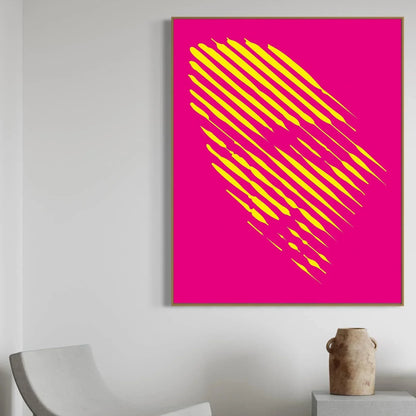 Framed artwork with yellow abstract design on a pink background, displayed on a wall.