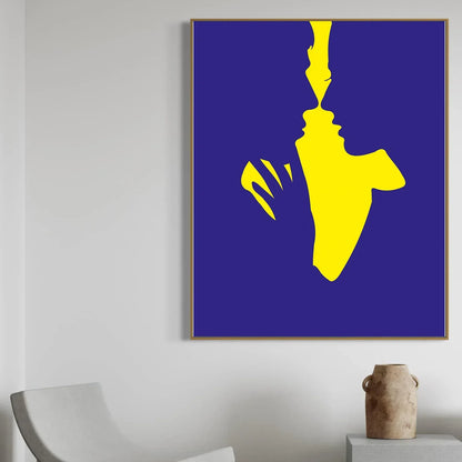Abstract art piece with yellow silhouette on a blue background in a modern interior setting.