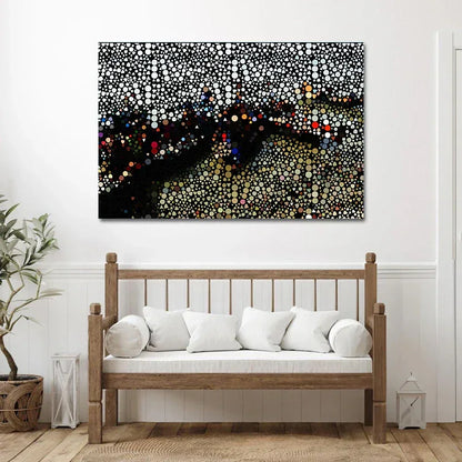 Abstract artwork on a wall above a wooden bench with white cushions.