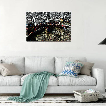 Abstract artwork on a wall above a white sofa with decorative pillows.