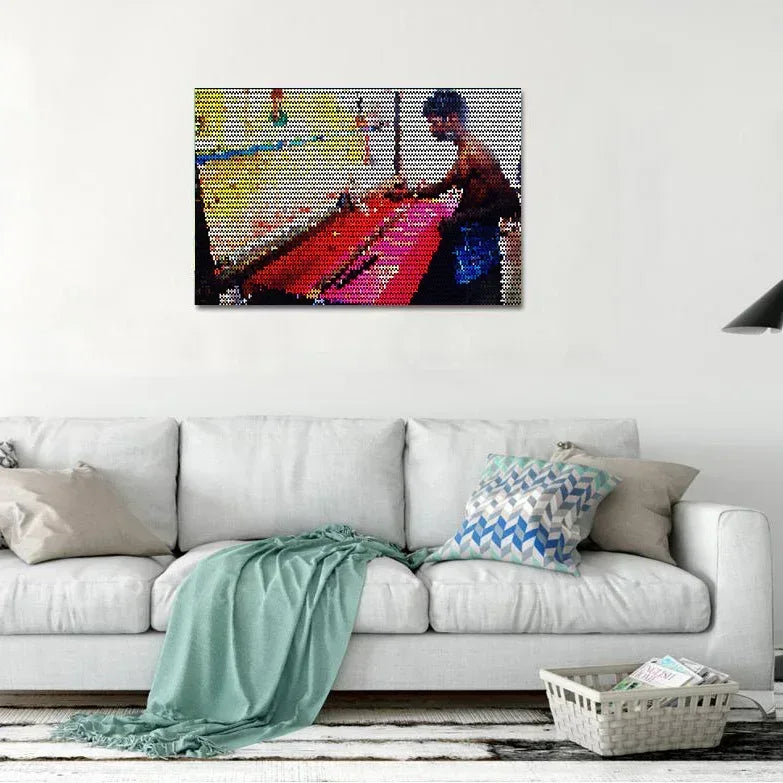 Colorful mosaic artwork of a person playing a keyboard on a white wall above a sofa.