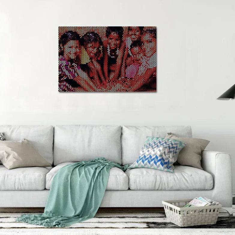 Colorful mosaic artwork of a group of people on a wall above a white sofa.