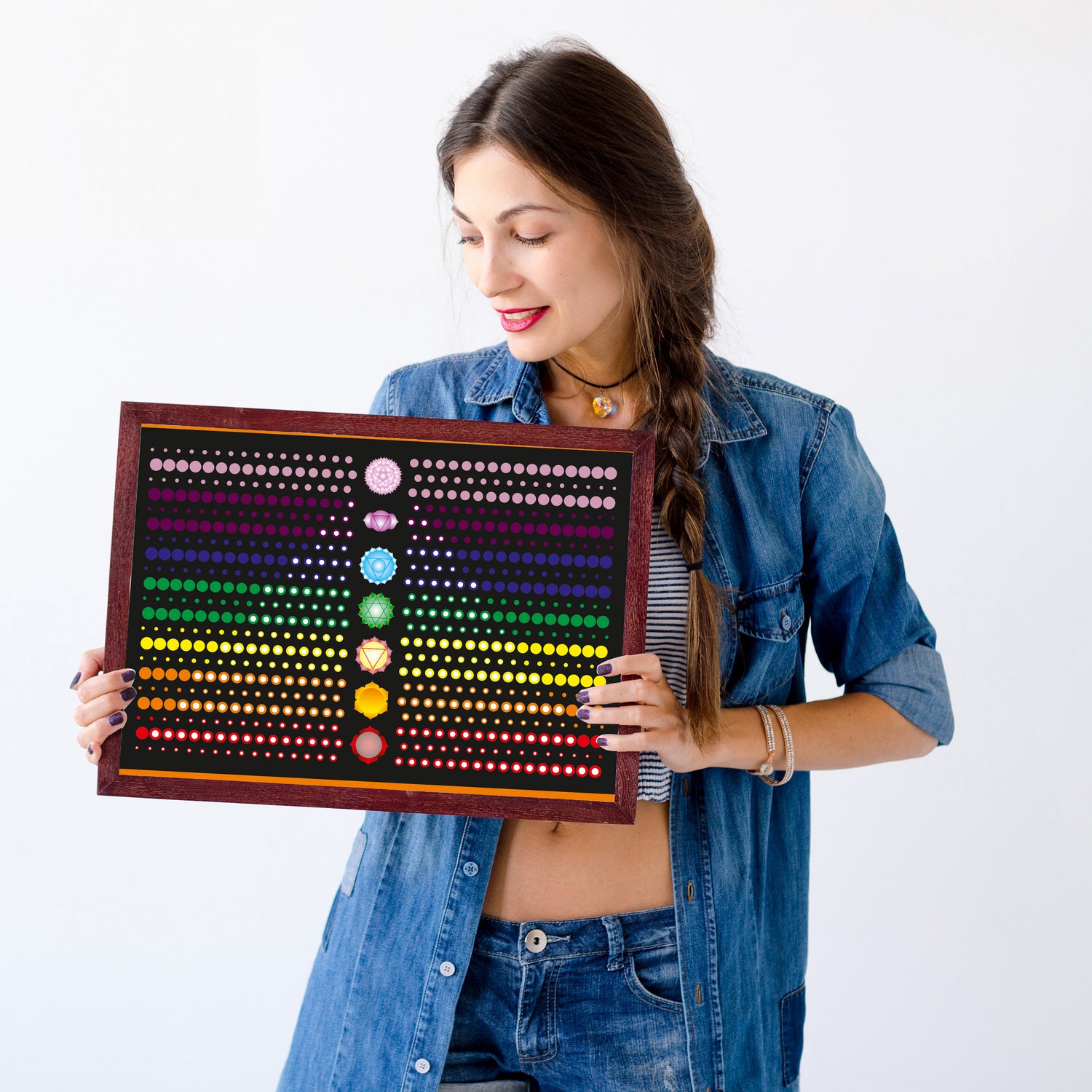Woman holding a colorful dot board against a white background