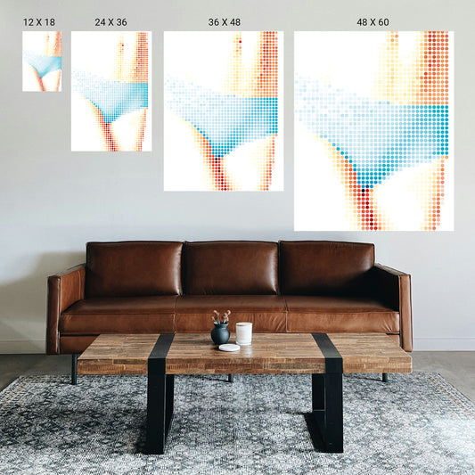 Brown leather sofa with a wooden coffee table in a room with abstract art on the wall.