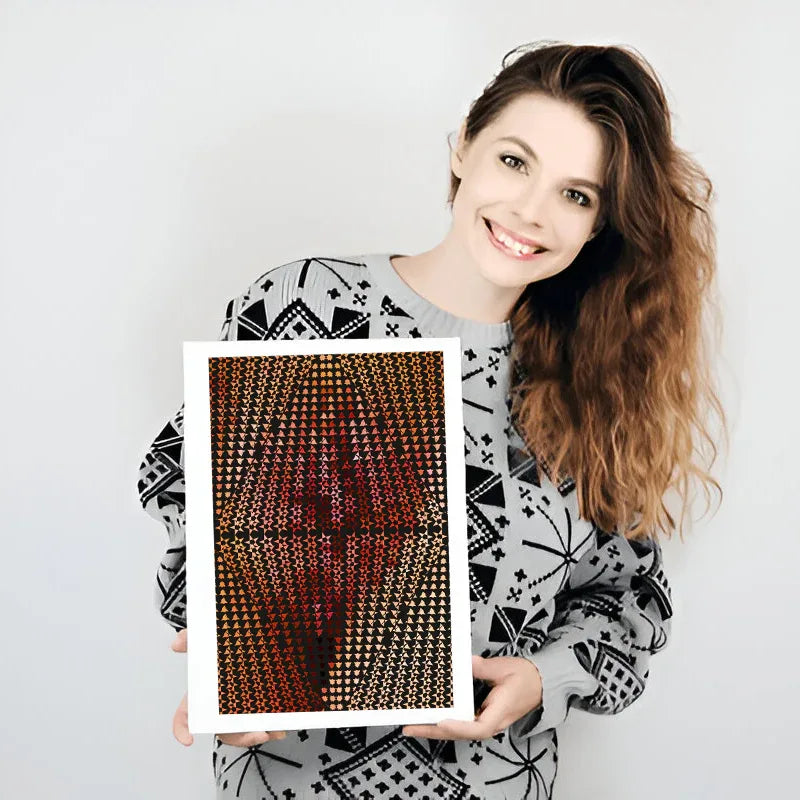 Woman holding a framed artwork with abstract design on a plain background