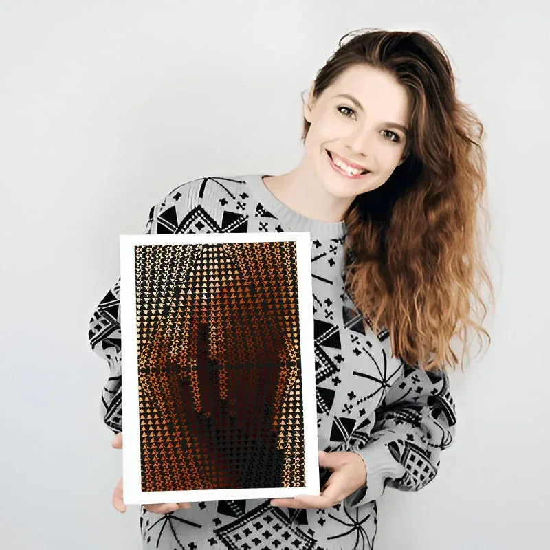 Woman holding a framed artwork with a geometric pattern on a plain background