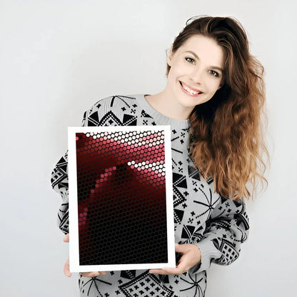 Woman holding a photo frame with a red and black pattern against a white background