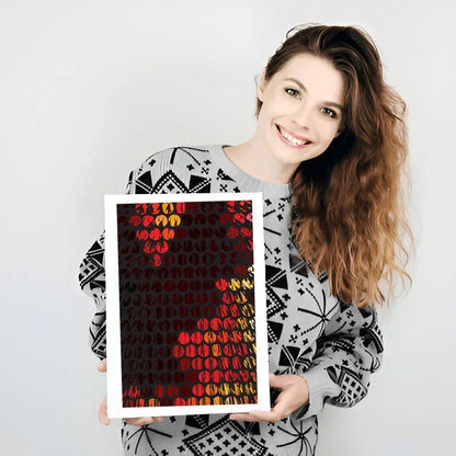Woman holding a framed artwork with geometric patterns on a plain background