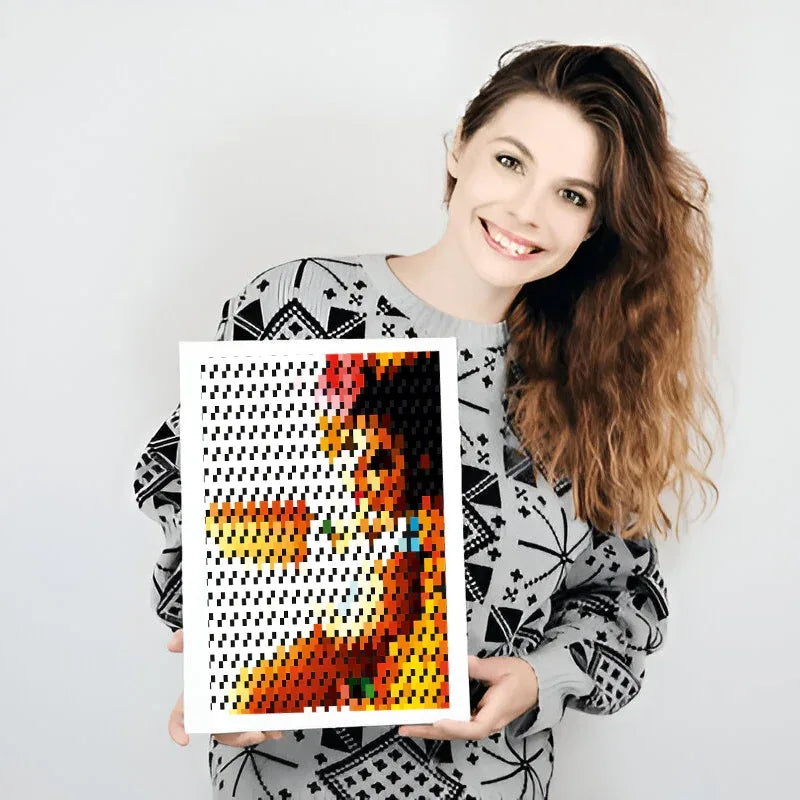 Woman holding a pixel art-style painting of a colorful abstract design.