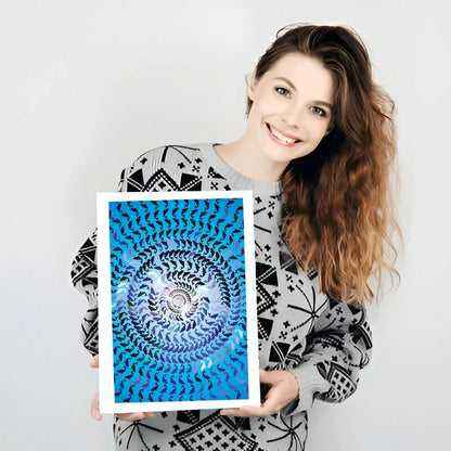 Woman holding a framed blue and white spiral art print against a plain background