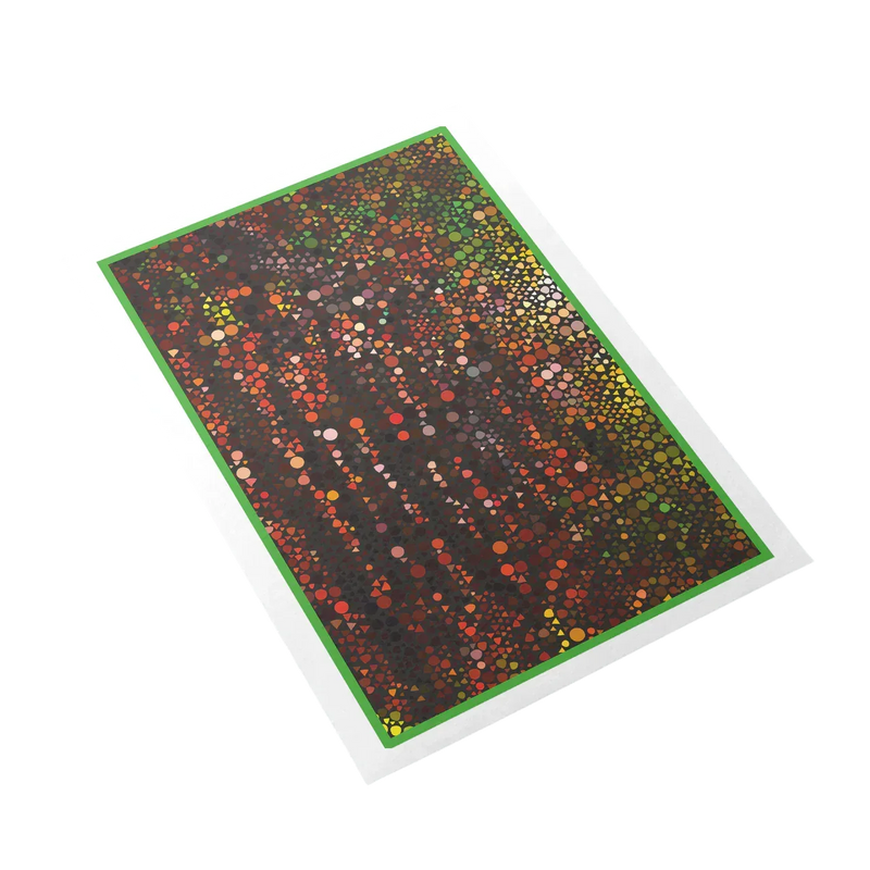 Colorful dot patterned mat with green border on a white background