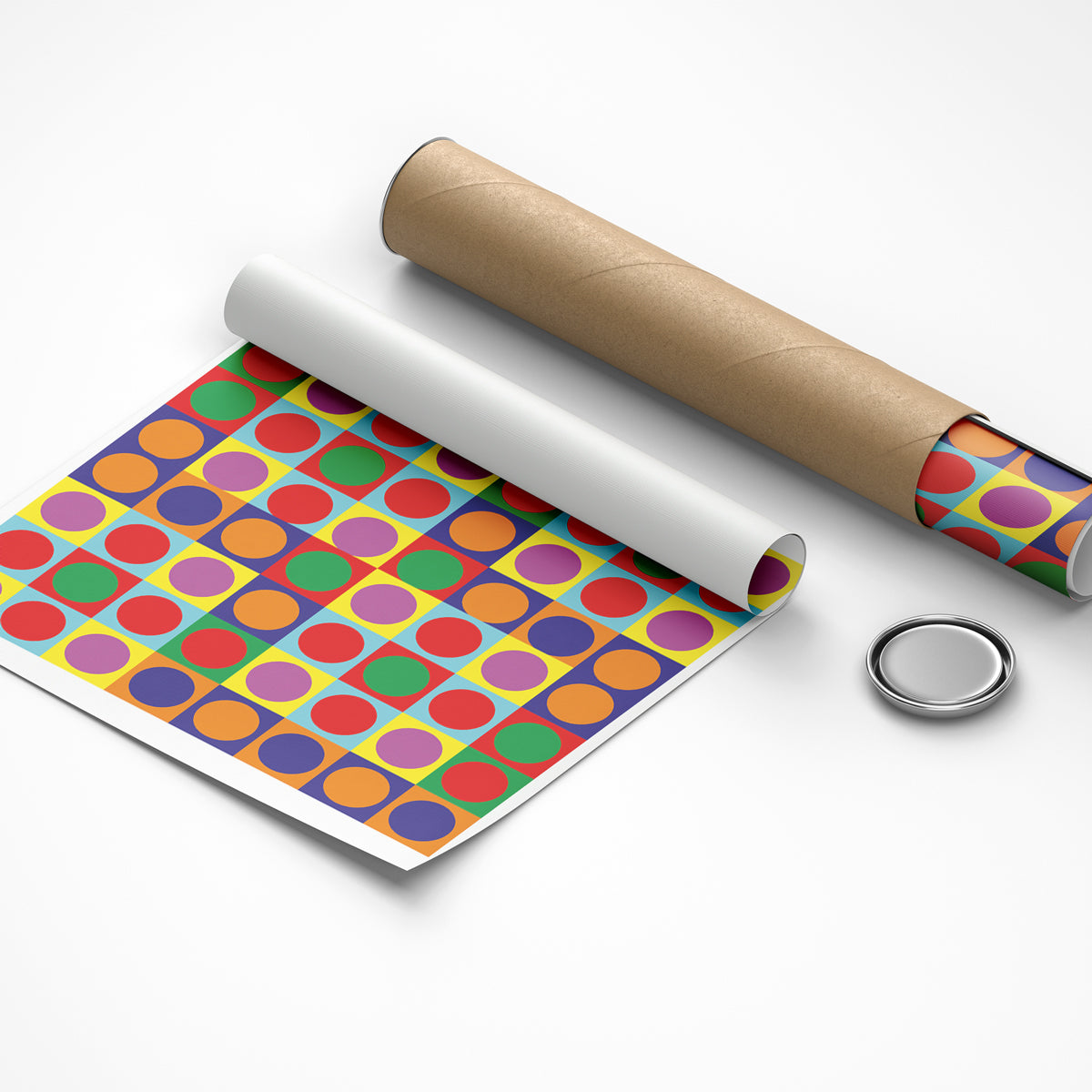 Colorful dot patterned paper with a roll of brown paper and a metal button on a white background