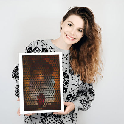 Woman holding a framed mosaic art piece against a plain background