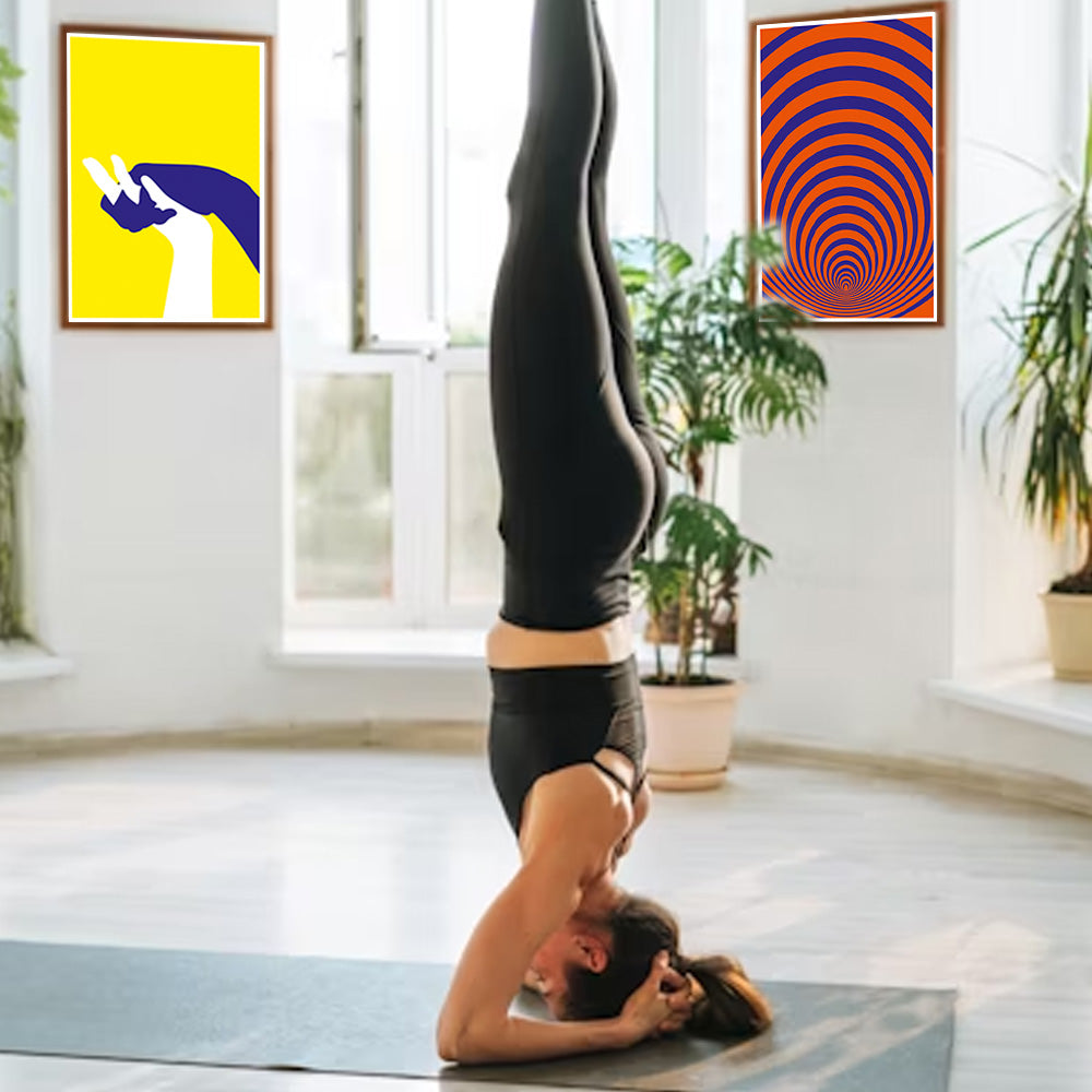 Person doing a handstand in a room with colorful abstract art on the walls.
