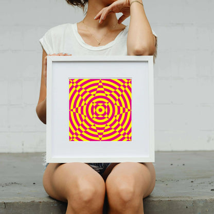 Person holding a framed pink and yellow spiral pattern against a white background
