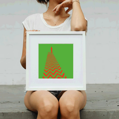 Person holding a framed artwork with a red and green design.