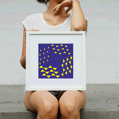 Person holding a framed artwork with geometric design