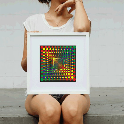Person holding a framed colorful dot artwork against a light gray background