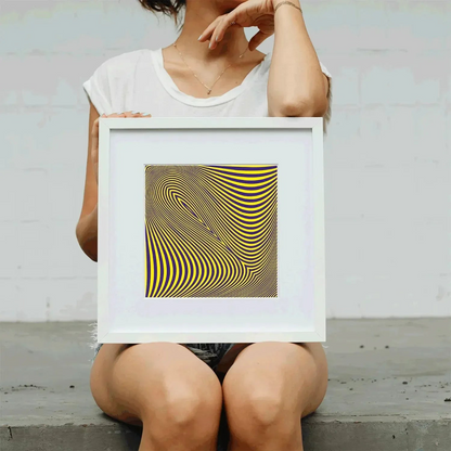 Person holding a framed piece of art with geometric design