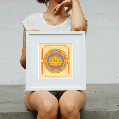 Person holding a framed geometric art print against a plain background